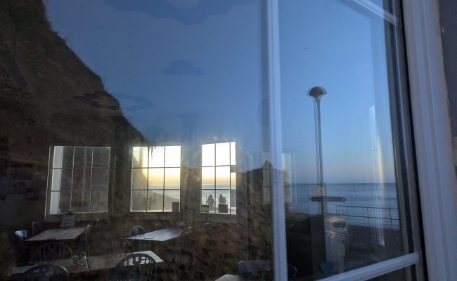 View into a cafe through window with reflections